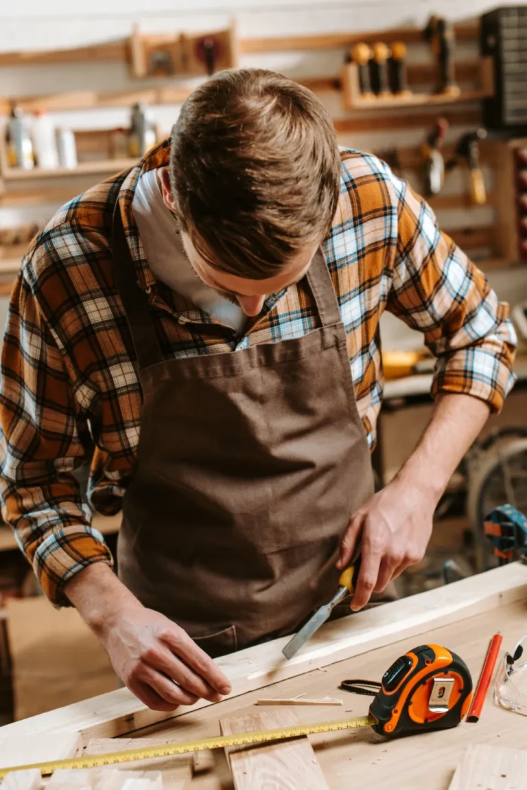 Carpenter shaping wood with a chisel