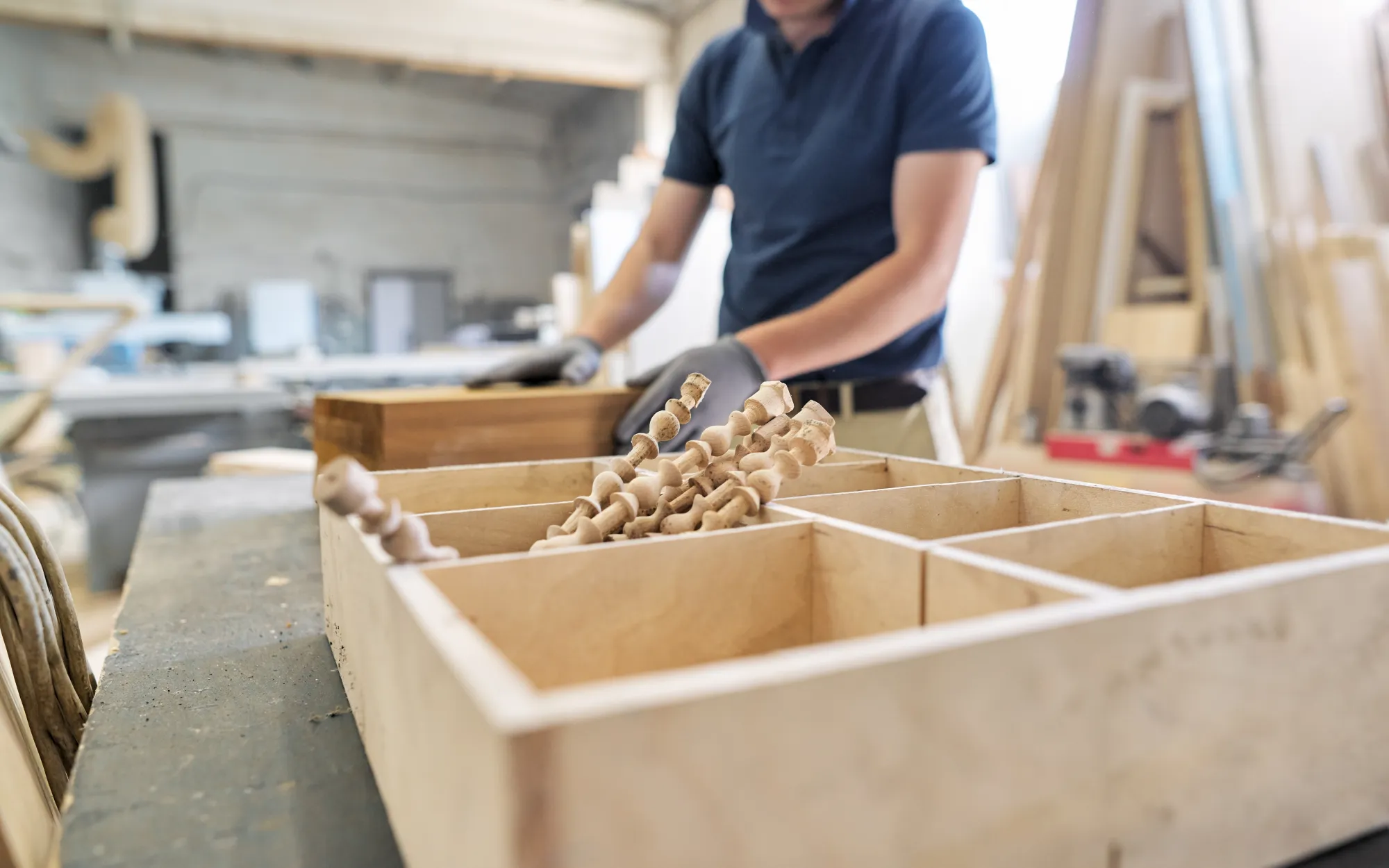 Woodworker inspecting wooden dowels in the workshop