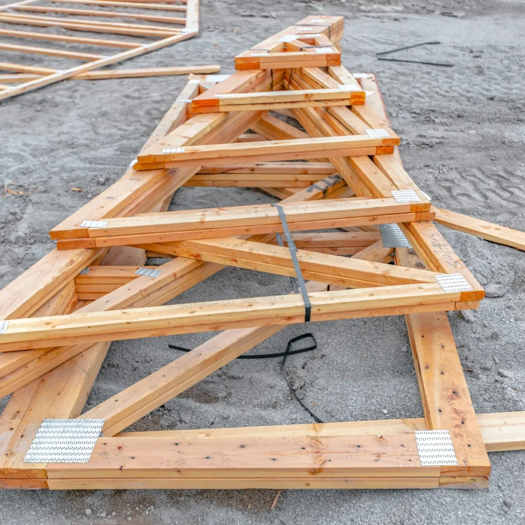 Timber roof trusses stacked on a construction site